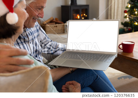 Christmas time, Senior couple enjoying holiday video call at home with laptop and coffee, copy space 120376635