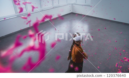 Talented Asian young woman wearing VR headset creates abstract online artwork Talented Asian young woman wearing VR headset creates abstract online artwork 120376640