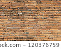 Weathered Orange Brick Wall Close-Up 120376759
