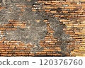 Weathered Brick Wall with Peeling Plaster 120376760