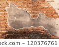 Brick Wall with Partially Peeling Plaster 120376761