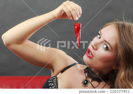Woman wearing lingerie holding chilli pepper 120377951
