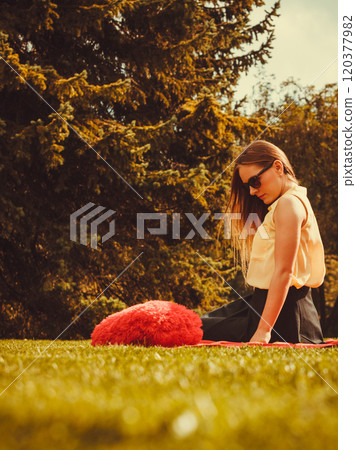 Smiling girl with heart in park. Smiling girl with heart in park. 120377982