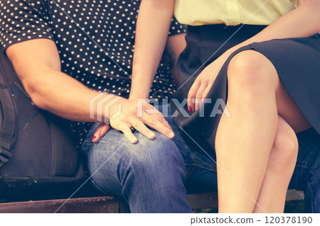 Girl sitting on boyfriends lap. 120378190