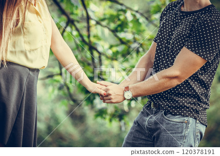 Couple holding hands in park. 120378191