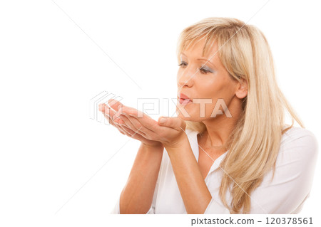 Portrait of mature woman blowing a kiss isolated Portrait of mature woman blowing a kiss isolated 120378561
