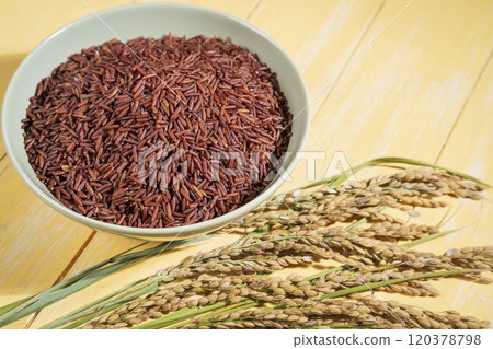 Red rice in wooden bowl and ears of rice close up Red rice in wooden bowl and ears of rice close up 120378798