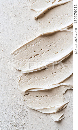 Beige textured cream spread on rough surface 120379011