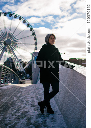 a young woman in front of the Ferris wheel in Gdansk a young woman in front of the Ferris wheel in Gdansk 120379162