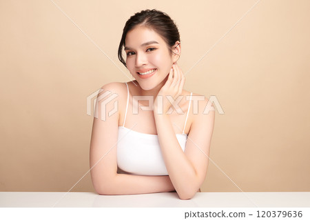 Beautiful young asian woman with clean fresh skin on beige background, Face care, Facial treatment, Cosmetology, beauty and spa, Asian women portrait. 120379636