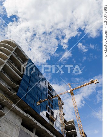 Modern crane near contemporary skyscraper 120379985