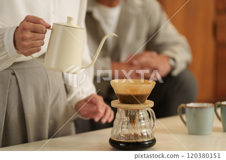 Couple brewing coffee at night 120380151
