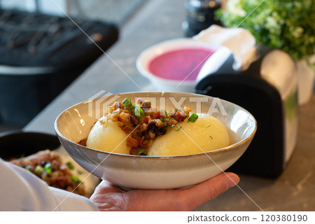 Traditional Lithuanian dish of stuffed potato dumplings (cepelinai). The dumplings are made from grated and riced potatoes and stuffed with ground meat or dry curd cheese or mushrooms 120380190