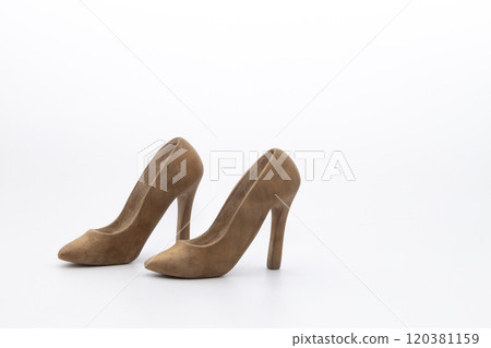 Pair of women's shoes made from wood. A beautiful high-heeled wooden shoes against white background. Handmade shoes for use in female concept 120381159