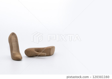 Pair of women's shoes made from wood. A beautiful high-heeled wooden shoes against white background. Handmade shoes for use in female concept 120381160