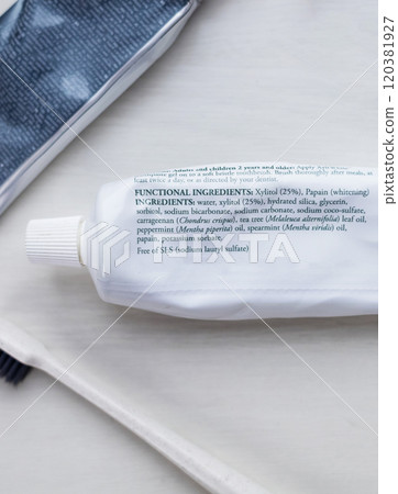 A tube of natural toothpaste with safe ingredients is lying on the table. List of natural components and ingredients. Use of ecological oral care products A tube of natural toothpaste with safe ingredients is lying on the table. List of natural components and ingredients. Use of ecological oral care products 120381927