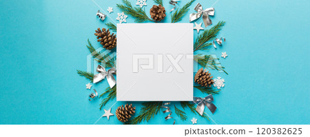 Flat lay Christmas composition. square Paper blank, pine tree branches, christmas decorations on Colored background. Top view, copy space for text 120382625