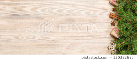 Christmas background with fir tree and gift box on wooden table. Top view with copy space for your design 120382653
