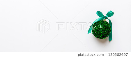 Christmas ball on colored background. decoration bauble with ribbon bow with copy space Christmas ball on colored background. decoration bauble with ribbon bow with copy space 120382697