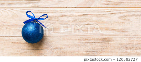 Christmas ball on colored background. decoration bauble with ribbon bow with copy space Christmas ball on colored background. decoration bauble with ribbon bow with copy space 120382727