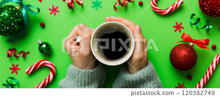 Woman holding cup of coffee. Woman hands holding a mug with hot coffee. Winter and Christmas time concept 120382749