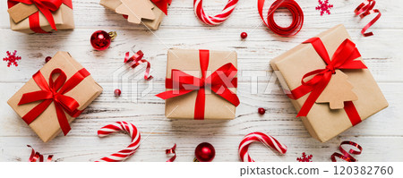 Christmas kraft gifts box with ribbon on colored background. Cozy Christmas still life, birthday or new year 120382760