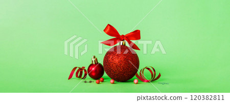 Christmas ball on colored background. decoration bauble with ribbon bow with copy space 120382811