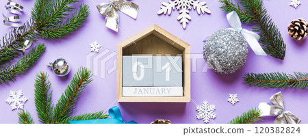 Christmas calendar 1 january. Christmas gift, fir branches, pine cones. Flat lay, top view. New Year decorations on a colored background 120382824