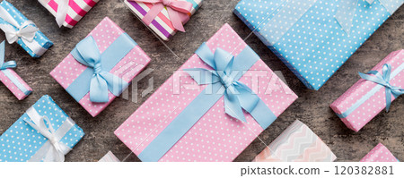 A lot of Christmas gift boxes in colored paper decorated on table, Top view close up. Many present New Year gift A lot of Christmas gift boxes in colored paper decorated on table, Top view close up. Many present New Year gift 120382881