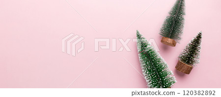 Flat lay composition with christmas trees on color background. Top view with copy space Flat lay composition with christmas trees on color background. Top view with copy space 120382892