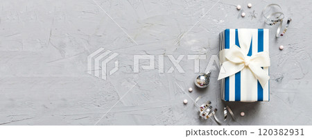 Top view Flat lay Christmas decorations and gift box on colored background with copy space. Christmas or Happy New Year composition Top view Flat lay Christmas decorations and gift box on colored background with copy space. Christmas or Happy New Year composition 120382931