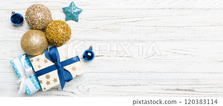 Top view Christmas ball, gift and creative decorations on wooden background. New Year holiday concept with copy space Top view Christmas ball, gift and creative decorations on wooden background. New Year holiday concept with copy space 120383114