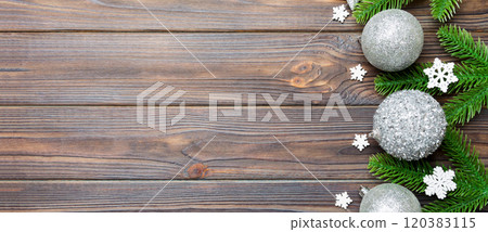 Christmas composition made of fir tree, balls and different decorations on wooden background. Top view of New Year Advent concept with empty space for your design Christmas composition made of fir tree, balls and different decorations on wooden background. Top view of New Year Advent concept with empty space for your design 120383115