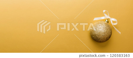 Christmas ball on colored background. decoration bauble with ribbon bow with copy space Christmas ball on colored background. decoration bauble with ribbon bow with copy space 120383163