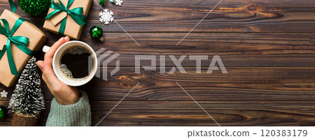 Woman holding cup of coffee. Woman hands holding a mug with hot coffee. Winter and Christmas time concept Woman holding cup of coffee. Woman hands holding a mug with hot coffee. Winter and Christmas time concept 120383179