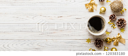 Delicious fresh festive morning coffee in a ceramic cup with little wrapped gifts, ornament and xmas toy. Cup of coffee and new year toys Delicious fresh festive morning coffee in a ceramic cup with little wrapped gifts, ornament and xmas toy. Cup of coffee and new year toys 120383180