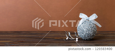 Christmas ball on colored background. decoration bauble with ribbon bow with copy space Christmas ball on colored background. decoration bauble with ribbon bow with copy space 120383400