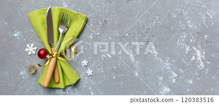 Christmas table place setting with knife, napkin and fork. Holidays new year background with copy space Christmas table place setting with knife, napkin and fork. Holidays new year background with copy space 120383516