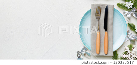 Christmas table place setting with christmas decor and plates, kine, fork and spoon. Christmas holiday background. Top view with copy space 120383517