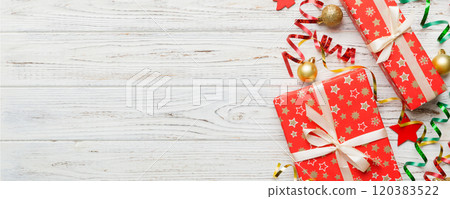 Holiday flat lay with gift boxes wrapped in colorful paper and tied decorated with confetti on colored background. Christmas, Birthday, Valentine and sale concept, top view 120383522