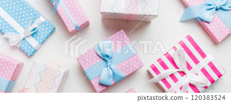 A lot of Christmas gift boxes in colored paper decorated on table, Top view close up. Many present New Year gift 120383524