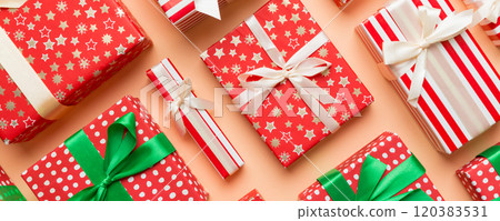 A lot of Christmas gift boxes in colored paper decorated on table, Top view close up. Many present New Year gift 120383531