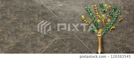 Creative flat lay composition with bottle of champagne and space for text on color background. Champagne bottle with colorful party streamers. holiday or christmas concept 120383545