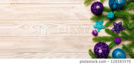 Christmas composition made of fir tree, balls and different decorations on wooden background. Top view of New Year Advent concept with empty space for your design Christmas composition made of fir tree, balls and different decorations on wooden background. Top view of New Year Advent concept with empty space for your design 120383570