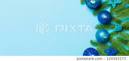 Christmas composition made of fir tree, balls and different decorations on colorful background. Top view of New Year Advent concept with empty space for your design 120383573