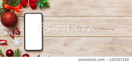 Digital phone mock up with rustic Christmas decorations for app presentation top view with empty space for you design. Christmas online shopping concept. Tablet with copy space on colored background Digital phone mock up with rustic Christmas decorations for app presentation top view with empty space for you design. Christmas online shopping concept. Tablet with copy space on colored background 120383580
