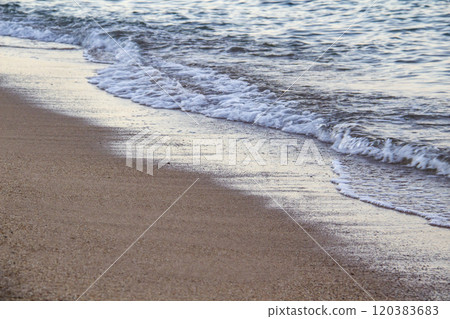 The beach with sea waves running on the sand. Beautiful view on the waves 120383683