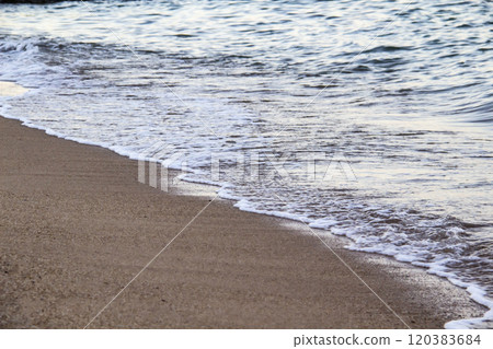 The beach with sea waves running on the sand. Beautiful view on the waves 120383684