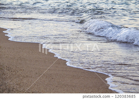The beach with sea waves running on the sand. Beautiful view on the waves 120383685