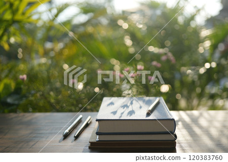 Stack of notebooks on wooden table outdoor 120383760